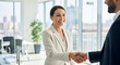 © Passionwith - Businesswoman Shaking Hands in Modern Office