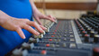 © Михаил Решетников - Hands Adjusting Sound Levels on Mixing Console.