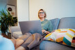 © okrasiuk - Cozy remote job. Confident Mid aged woman self employed sit on sofa at home office workplace do accounting work for remote client, has online study. Small business entrepreneur manage business at home