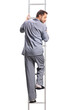 © Ljupco Smokovski - Rear view shot of a man in pajamas climbing a ladder and looking down