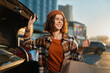 © SHOTPRIME STUDIO - Woman shopping by car trunk in urban parking, smiling with paper bag at golden hour glow. Candid lifestyle portrait conveying authenticity, mindful living and emotional storytelling mood.