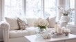 © mila103 - A white couch is sitting in front of a window with a vase of white flowers on it. The room is decorated with white furniture and white accessories, giving it a clean and minimalist look