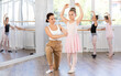 © JackF - At ballet lesson, mentor corrects girls arm and leg, teaches correct dynamics and execution of movements. Makes remarks during lesson