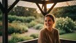 © Nasty - Young woman smiling while sitting under gazebo in garden during rain rain shelter pavilion