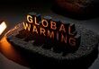 © Meow Creations - Dramatic low key shot of GLOBAL WARMING text blocks glowing orange on dark rock