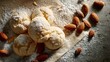 © Yasith - A close up of almond cookies dusted with powdered sugar on parchment paper with scattered almonds