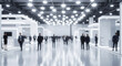 © Anuyj - Blurred expo hall. Many people walk. Booths with displays visible. Lots of people move around. Busy business event. Modern business conference. Corporate exhibition. Networking event. Lots of people