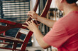 © YanlethRivera - Cabinetmaker man adjusting a wooden chair with a wrench in the workshop. Male cabinetmaker working repairing a chair in the carpentry shop