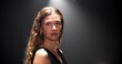 © peopleimages.com - Fashion, woman and portrait of runway model in studio for glamour, chic and dark background. Trendy, stylish person and confidence for clothing show, designer brand and aesthetic with mockup space