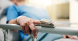 © peopleimages.com - Hands, old person and oximeter in hospital bed to monitor pulse, blood pressure and surgery recovery. Closeup, elderly patient and medical machine to track oxygen, chronic condition and critical care