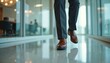 © Maryna - Businessman in formal suit strides fast through office corridor, elegant brown shoes reflecting on glossy floor. Pro late for corporate meeting, legs moving with purpose. Portrays urgency,