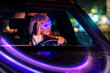 © Cavan Images - young woman driving car at night wearing futuristic AR glasses