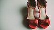 © Mariia - Elegant red high heels on a neutral background ready for a stylish night out or special occasion