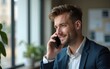 © Alexander - Young handsome man talking on the phone at the office. High quality