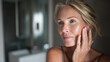 © ink drop - Mature woman applying moisturiser while embracing natural skin changes and midlife well being