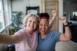 © Marko Geber - Mature women friends celebrate happy workout selfie at gym