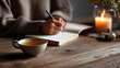 © Paula - Woman journaling with candlelight and tea on wooden table
