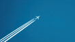 © Yuan - contrail. An airplane flies through a clear blue sky, leaving white trails behind. mobility guides, transit brochures, designed for mobility and urban transit guides, used by video editors.
