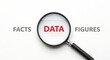 © Stocker Man - Magnifying glass over the word data, with facts and figures on either side, isolated on white background