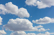 © Mint Images - Blue sky and fluffy white cumulus clouds