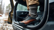 © Bob - Adventurer, touirst or hiking affectionate changes shoes inside car after or before long wet walk in harsh conditions. Puts on pair or clean and dry wool socks to warm up feet in cold weather