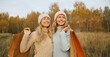 © rohappy - Happy women friends with shopping bags, smiling girlfriends together in autumn park