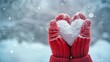 © bborriss - Cozy winter scene  red knitted mittens embrace a snow heart amidst sparkling snow and love