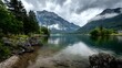© Khalid - Scenic tranquil lakeside with alpine backdrop and clouds floating by