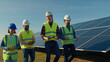 © Videophilia - Professionals discuss solar energy project during daytime at solar panel installation site, emphasizing teamwork and renewable energy solutions