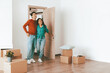© Prostock-studio - A man and woman stand in the doorway of an empty room, smiling as they step inside their new home.