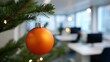 © OleksandrZastrozhnov - Festive office decor with orange bauble on christmas tree branch
