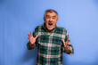 © EDER - Elderly man screaming in shock on blue background