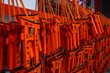 © Aerial Film Studio - Rows of orange torii ema hang with handwritten wishes at Fushimi Inari Taisha in Kyoto, soft indoor lighting and shallow depth of field emphasize texture and script