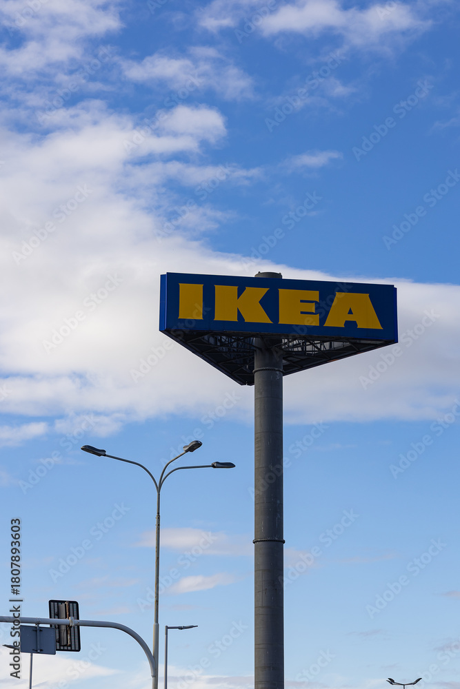 An Ikea store sign with the blue and yellow logo on a bright day.