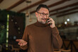© Miljan Živković - Man talking on mobile phone looking surprised and gesturing