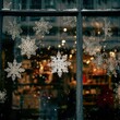 © Eolo Pics - Window display with hanging snowflakes and blurred lights creating a festive winter atmosphere indoors