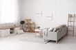 © Pixel-Shot - Interior of light living room with comfortable sofa, bench, coffee table and shelving unit
