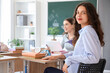 © Pixel-Shot - Female student sitting at desk in classroom