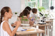 © Pixel-Shot - Pupils studying at desks in Biology class