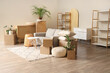 © Pixel-Shot - Interior of living room with grey sofa and cardboard boxes on moving day