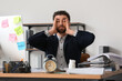 © Pixel-Shot - Stressed businessman with a lot of work sitting at table in office. Deadline concept