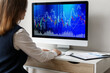 © Pixel-Shot - Female trader working with computer at table in office