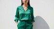 © Margarita Ratatosk - Woman wearing elegant green blouse and trousers. Fashionable clothing for everyday wear or festive event. Stylish design.