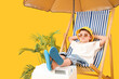 © Pixel-Shot - Cute little boy sitting in deck chair with beach cooler and umbrella on yellow background. Travel concept
