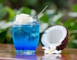 © Rama - Refreshing blue coconut cocktail with a scoop of ice cream on a wooden table.