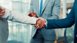 © peopleimages.com - Business people, meeting and team with handshake for deal, agreement or partnership in office. Group, employees or colleagues shaking hands for b2b introduction, onboarding or welcome in workplace