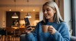 © Shakir - Young Woman with Blonde Hair Smiling While Holding Coffee Cup and Using Smartphone happy