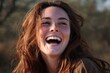 © Iftikhar alam - Joyful woman laughing brightly in the warm sun during an outdoor gathering amidst nature showing happiness and carefree spirit