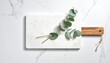 © Abdul - Marble board, wood handle, eucalyptus branch on marble background