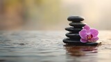 Zen spa composition with black stones and purple orchid, reflection in water, peaceful wellness background, minimalist design, copy space on left, meditation concept